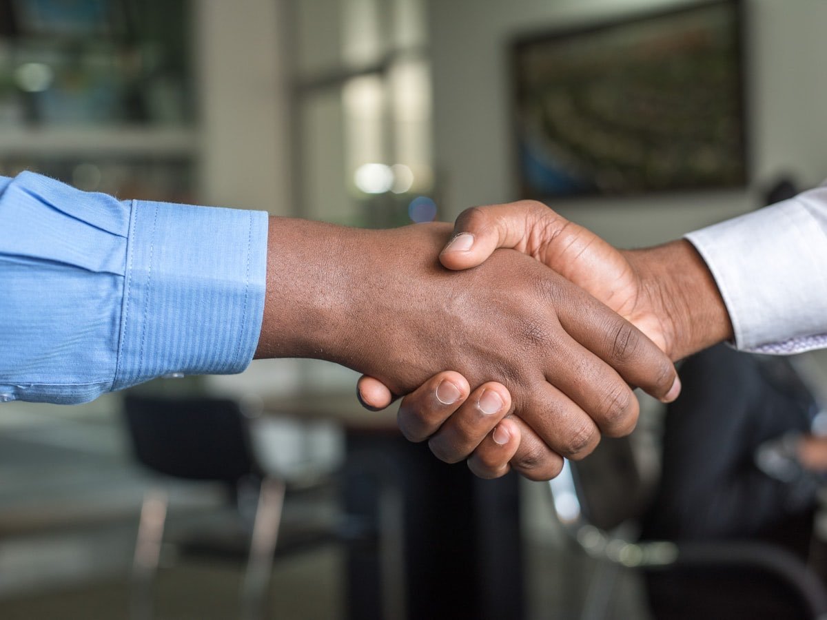 Two partners shaking hands on an agreement