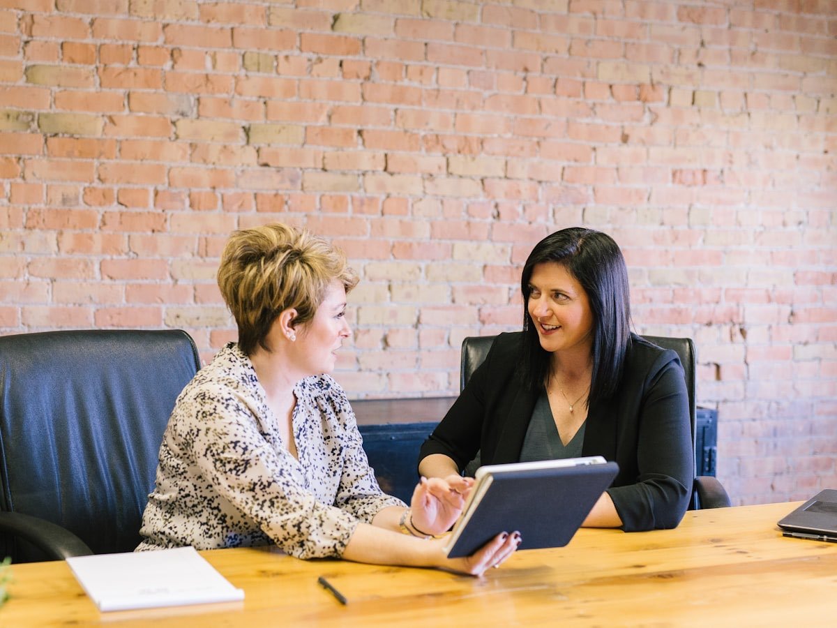An adviser answering a client’s questions over a tablet