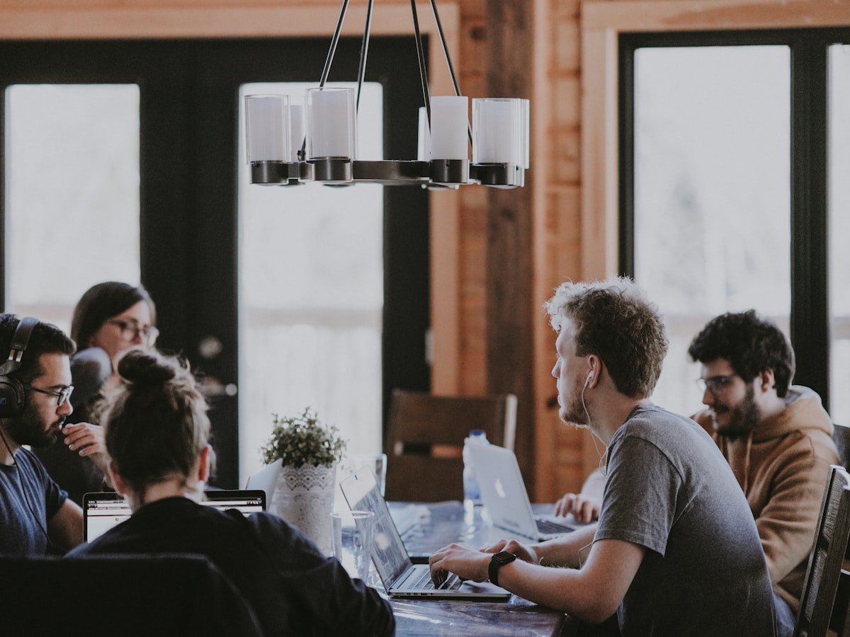 An advisory team working through client files around a meeting table