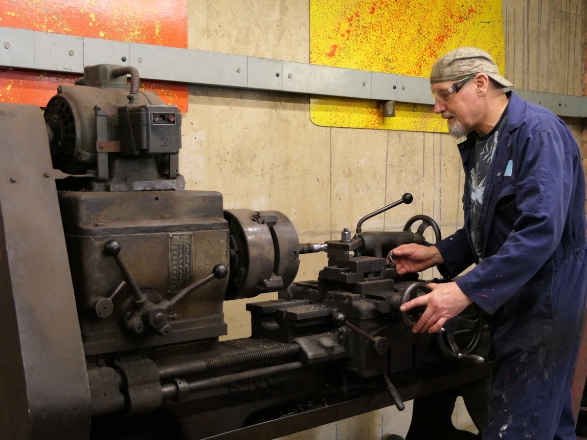 An operator at a lathe in a small engineering workshop