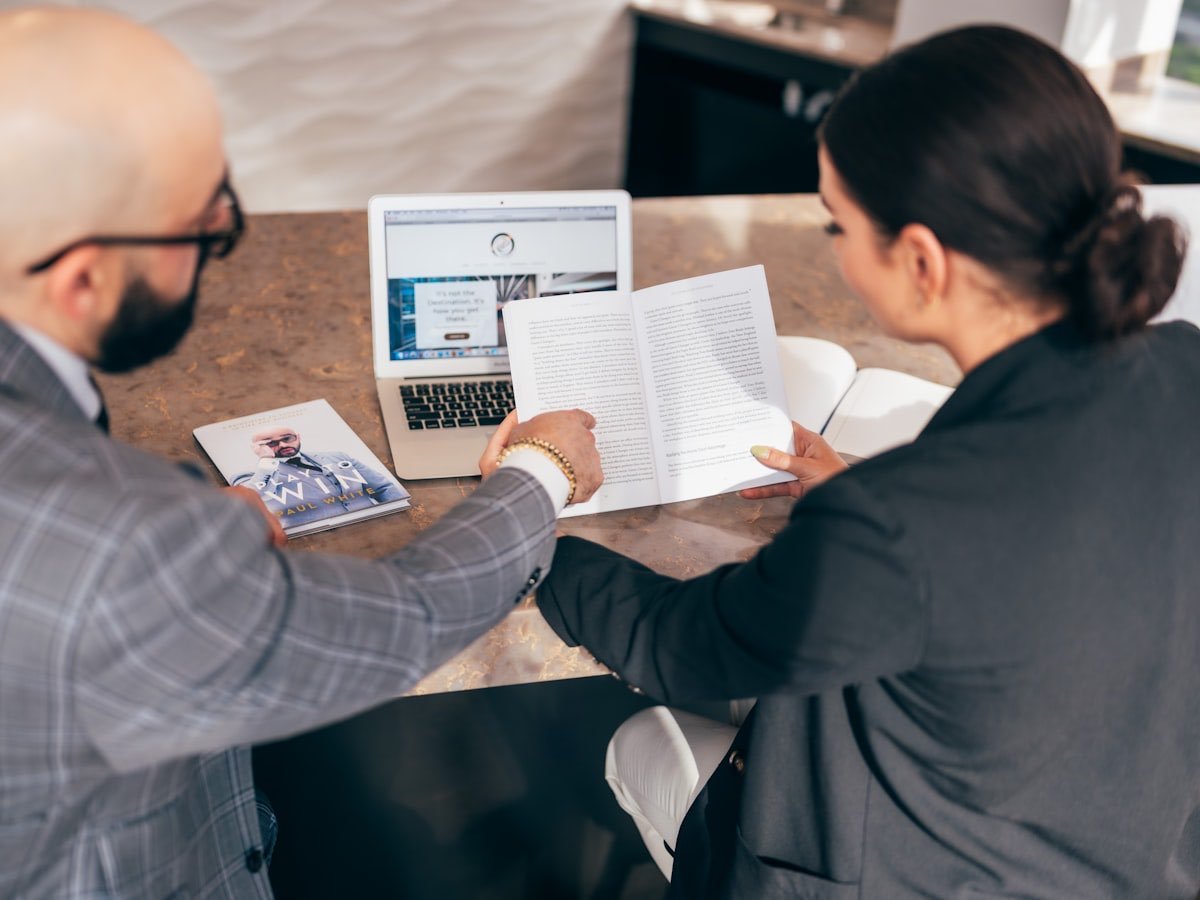 An adviser and client reviewing a loan file together